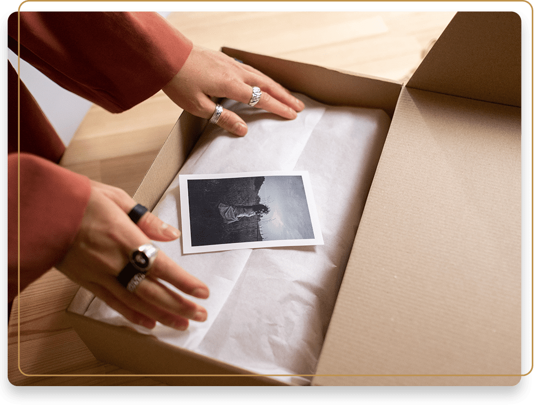 A person opening up an open box with a picture of a baby.