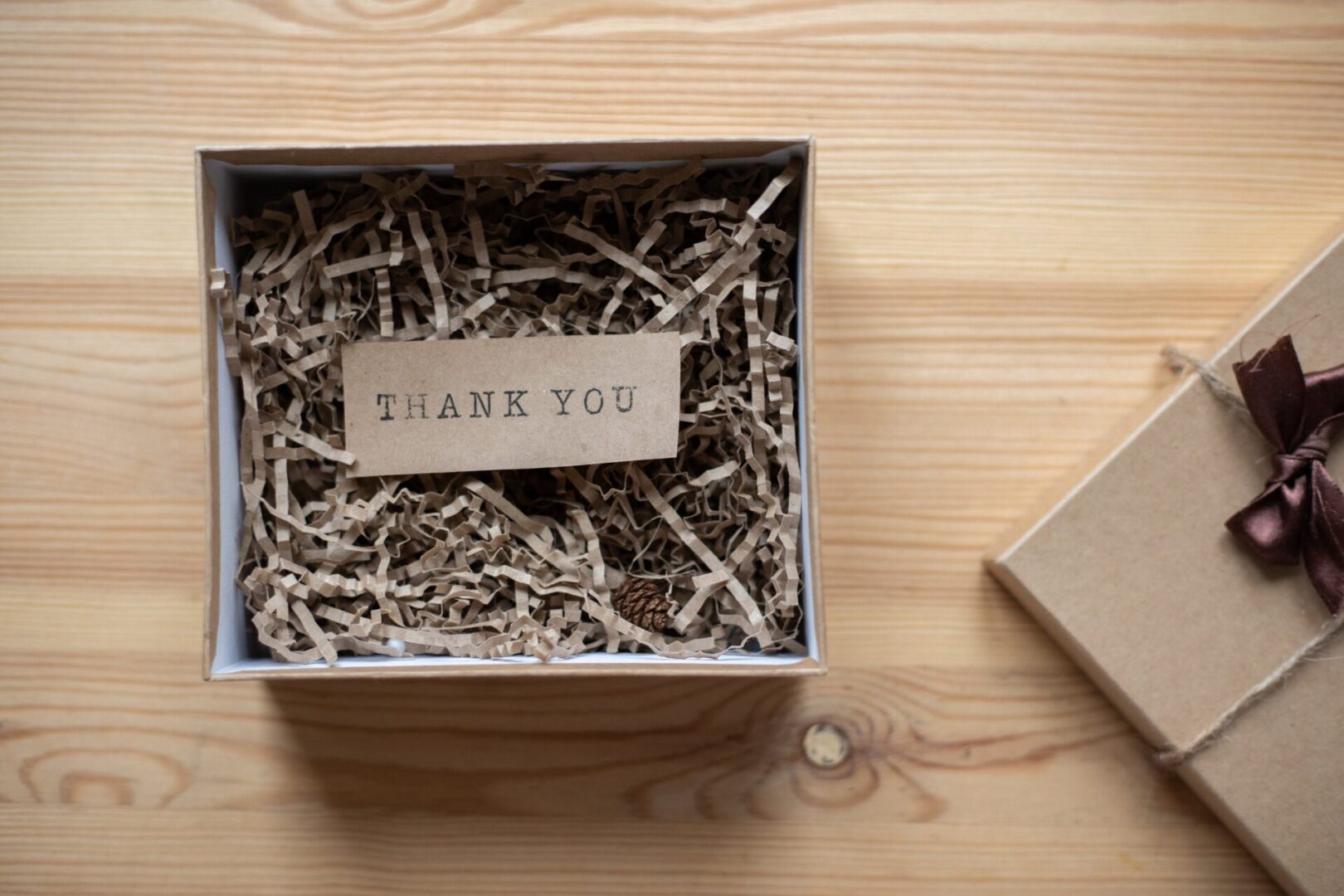 A box with shredded paper and a thank you note.